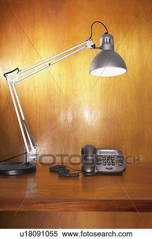 Stock Photography - Lamp and telephone on desk. Fotosearch