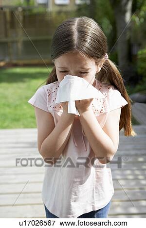 Little girl in backyard blowing nose View Large Photo Image Stock Photo - Little girl in backyard blowing nose. Fotosearch