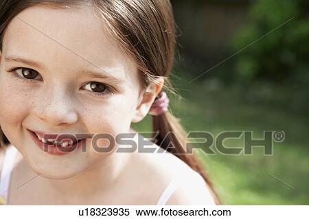 Little Girl sitting in backyard, portrait, close up View Large Photo Image Stock Photography - Little Girl sitting in backyard, portrait, close up. Fotosearch