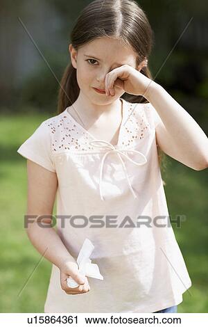 Little girl with cold rubbing eyes in backyard, portrait View Large Photo Image Stock Image - Little girl with cold rubbing eyes in backyard, portrait. Fotosearch