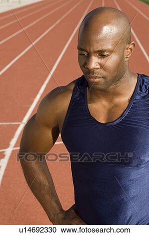 Stock Image - Male athlete at stadium. Fotosearch
