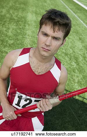 Stock Image - Male athlete holding javelin, portrait. Fotosearch