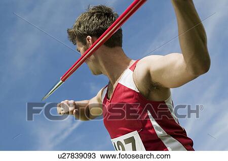Stock Image - Male athlete holding javelin. Fotosearch