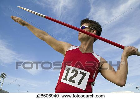 Stock Image - Male athlete holding javelin. Fotosearch