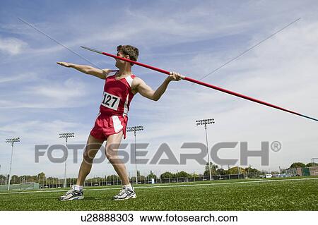 Male athlete holding javelin View Large Photo Image Stock Image - Male athlete holding javelin. Fotosearch