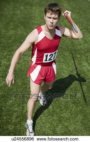 Stock Photograph - Male athlete holding javelin. Fotosearch