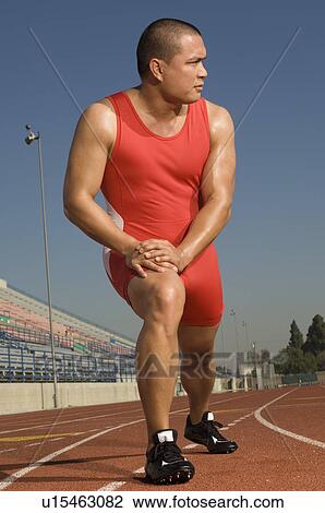 Male athlete stretching on track View Large Photo Image Stock Image - Male athlete stretching on track. Fotosearch