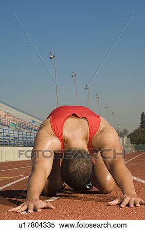 Male athlete stretching on track View Large Photo Image Stock Photography - Male athlete stretching on track. Fotosearch