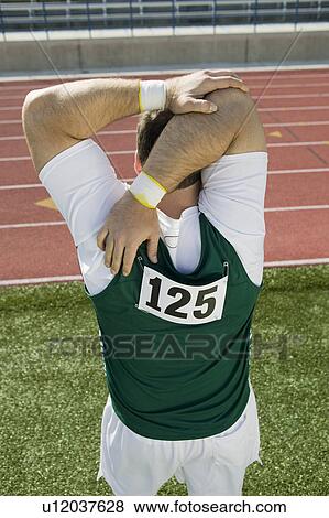 Stock Photo - Male athlete stretching. Fotosearch