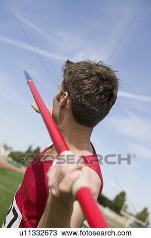 Male athlete throwing javelin View Large Photo Image Stock Image - Male athlete throwing javelin. Fotosearch
