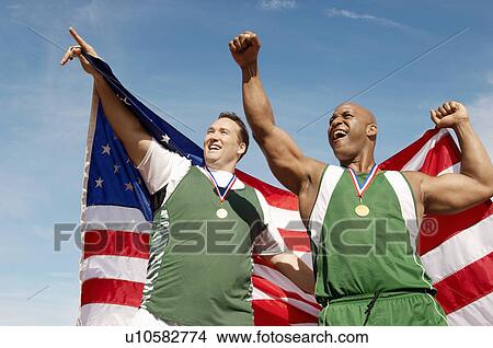 Male athletes celebrating with medals and American flag View Large Photo Image Picture - Male athletes celebrating with medals and American flag. Fotosearch