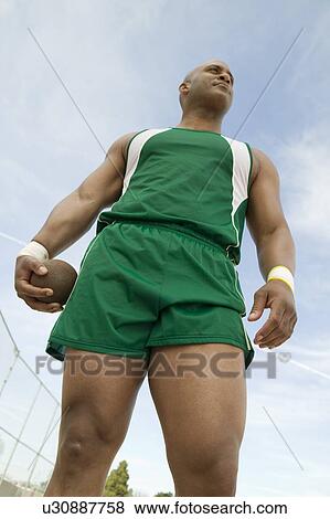 Male shot putter holding shot, low angle view View Large Photo Image Stock Photo - Male shot putter holding shot, low angle view. Fotosearch