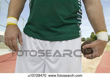 Male shot putter holding shot, mid section View Large Photo Image Stock Image - Male shot putter holding shot, mid section. Fotosearch