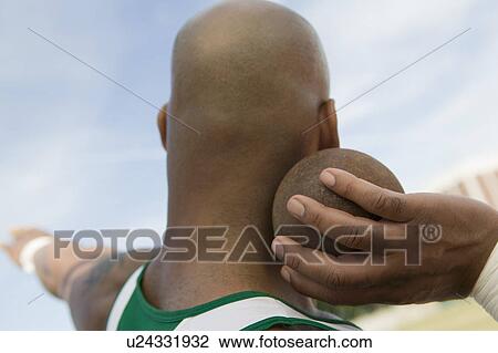 Male shot putter holding shot View Large Photo Image Stock Image - Male shot putter holding shot. Fotosearch