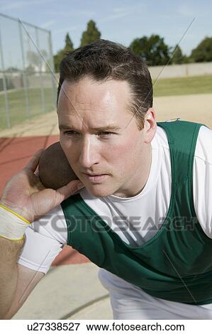 Male shot putter holding shot View Large Photo Image Stock Photo - Male shot putter holding shot. Fotosearch