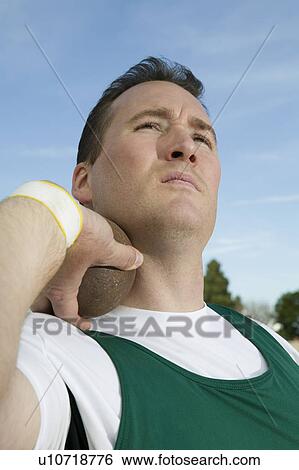 Male shot putter holding shot View Large Photo Image Stock Photograph - Male shot putter holding shot. Fotosearch
