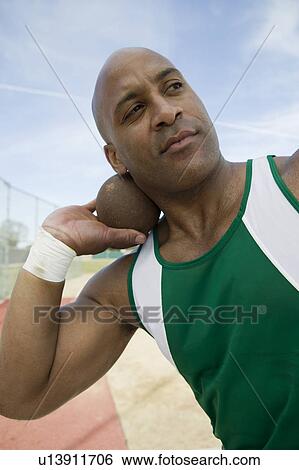 Male shot putter holding shot View Large Photo Image Stock Photograph - Male shot putter holding shot. Fotosearch