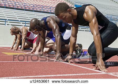 Male sprinters in starting blocks View Large Photo Image Stock Image - Male sprinters in starting blocks. Fotosearch