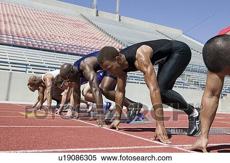 Male sprinters in starting blocks View Large Photo Image Stock Photography - Male sprinters in starting blocks. Fotosearch
