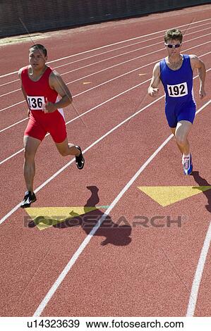 Stock Photo - Male sprinters running on track. Fotosearch