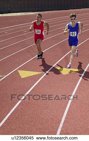 Male sprinters running on track View Large Photo Image Stock Photography - Male sprinters running on track. Fotosearch