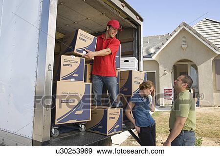 Man and couple unloading truck of cardboard boxes View Large Photo Image Stock Photo - Man and couple unloading truck of cardboard boxes. Fotosearch