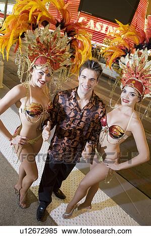 Stock Photography - Man and female dancers having fun. Fotosearch