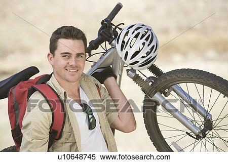 Man carrying mountain bike View Large Photo Image Stock Photography - Man carrying mountain bike. Fotosearch