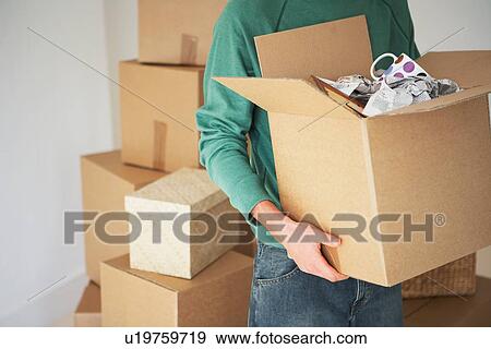 Stock Photo - Man Carrying open Cardboard Box. Fotosearch