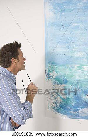 Man contemplating paintings in gallery View Large Photo Image Stock Photography - Man contemplating paintings in gallery. Fotosearch