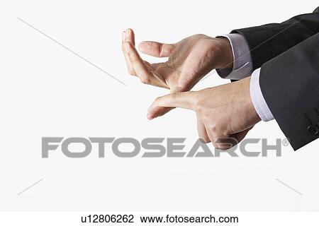 Stock Image - Man counting using fingers, close-up of hands. Fotosearch