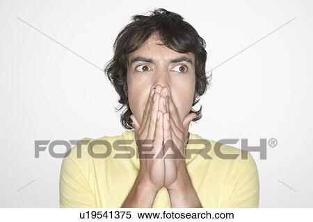 Man covering mouth with both hands, close-up View Large Photo Image Stock Photography - Man covering mouth with both hands, close-up. Fotosearch