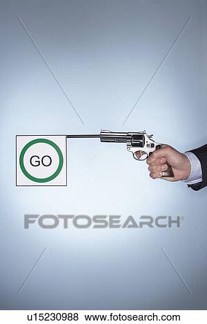 Man firing pistol with go flag, close-up of hand View Large Photo Image Stock Photo - Man firing pistol with go flag, close-up of hand. Fotosearch
