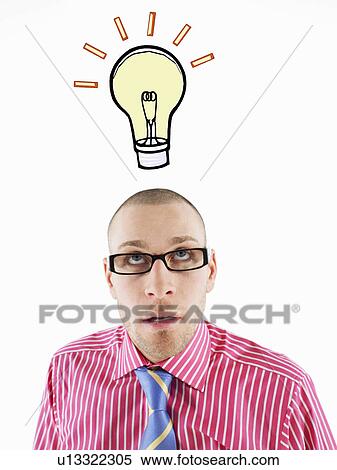 Stock Photography - Man in glasses looking up, head and shoulders, below illustrated light bulb. Fotosearch