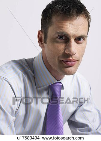 Man in tie in studio, head and shoulders View Large Photo Image Picture - Man in tie in studio, head and shoulders. Fotosearch