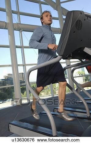 Man Jogging on Treadmill at Gym View Large Photo Image Stock Photograph - Man Jogging on Treadmill at Gym. Fotosearch