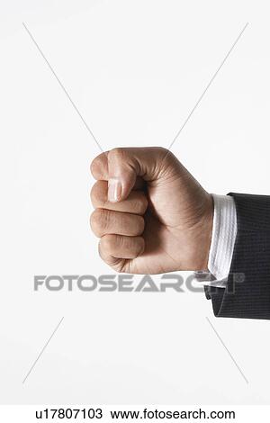 Stock Image - Man making fist, close-up of hand. Fotosearch