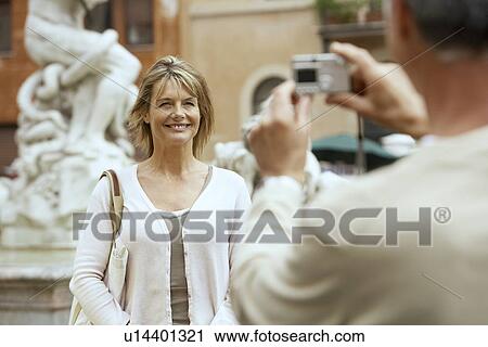Man photographing partner by statue in Rome, Italy, focus on woman View Large Photo Image Stock Image - Man photographing partner by statue in Rome, Italy, focus on woman. Fotosearch