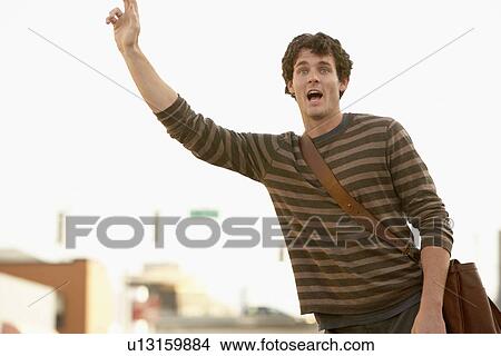 Man signalling taxi in street View Large Photo Image Picture - Man signalling taxi in street. Fotosearch