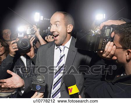 Man surrounded by paparazzi View Large Photo Image Stock Image - Man surrounded by paparazzi. Fotosearch