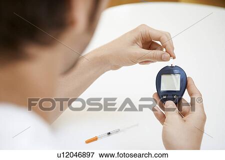 Man Using Blood Sugar Meter in bathroom View Large Photo Image Stock Photo - Man Using Blood Sugar Meter in bathroom. Fotosearch