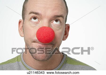 Man Wearing Clown Nose, looking upwards in disgust View Large Photo Image Stock Image - Man Wearing Clown Nose, looking upwards in disgust. Fotosearch