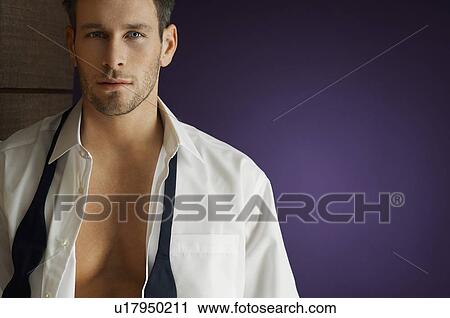 Stock Image - Man wearing tuxedo, indoors, portrait. Fotosearch