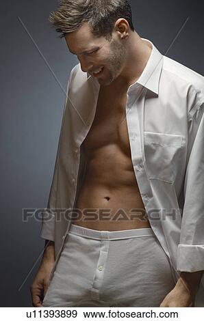 Man wearing underwear and shirt, portrait View Large Photo Image Stock Photo - Man wearing underwear and shirt, portrait. Fotosearch