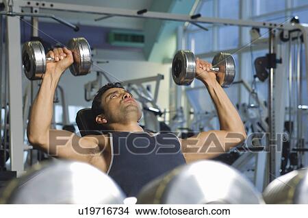 Man Weightlifting on Bench With Dumbbells View Large Photo Image Picture - Man Weightlifting on Bench With Dumbbells. Fotosearch