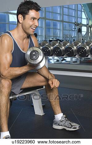 Stock Image - Man Weightlifting With Dumbbell. Fotosearch