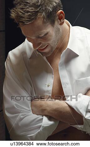 Picture - Man with arms crossed, close-up, portrait. Fotosearch