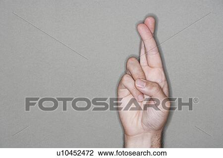 Man with fingers crossed, close-up on hand View Large Photo Image Stock Image - Man with fingers crossed, close-up on hand. Fotosearch