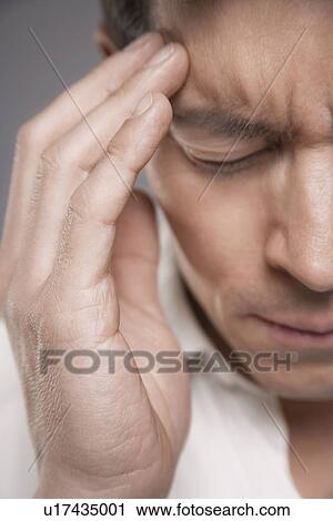 Man with hand pressed to forehead, close-up, cropped View Large Photo Image Stock Image - Man with hand pressed to forehead, close-up, cropped. Fotosearch