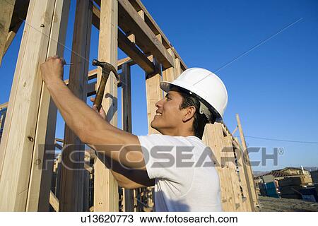 Stock Image - Man working in construction site. Fotosearch